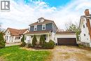 The property features a two-story design with blue siding on the upper level and white siding on the lower level, complemented by a brown roof - 30 Grand Avenue, Caledonia, ON 