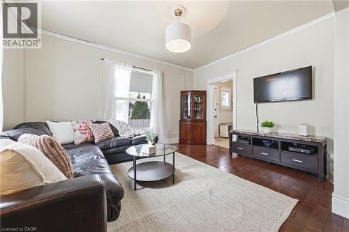 Living area featuring hardwood flooring, light-colored walls, and a window providing natural light - 30 Grand Avenue, Caledonia, ON 