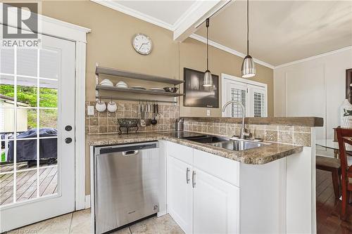The kitchen features a stainless steel dishwasher, a double basin sink, and granite countertops - 30 Grand Avenue, Caledonia, ON 