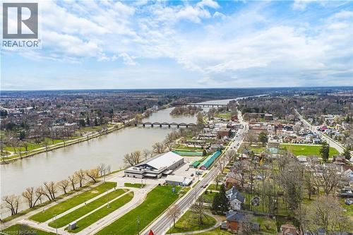 Aerial view showcasing the property's proximity to a river with bridges, a main road, and surrounding residential areas - 30 Grand Avenue, Caledonia, ON 