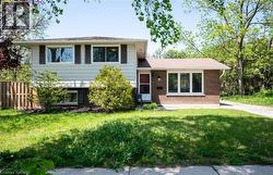 The property features a combination of white siding and brick exterior, with a brown shingle roof - 