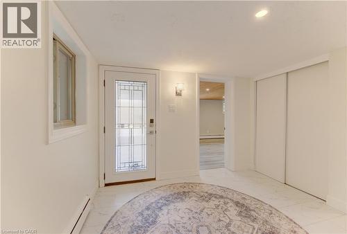 Entryway featuring a white door with decorative glass, a window with white trim, and white walls - 400 Manchester Road, Kitchener, ON - Indoor Photo Showing Other Room
