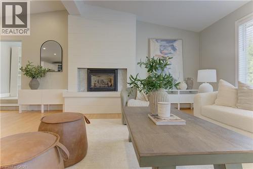 Spacious living area featuring a fireplace, light hardwood floors, and vaulted ceilings - 400 Manchester Road, Kitchener, ON - Indoor Photo Showing Living Room With Fireplace