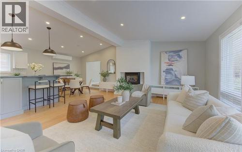 Spacious open concept living area featuring a fireplace, hardwood floors, recessed lighting, and a window with blinds - 400 Manchester Road, Kitchener, ON - Indoor Photo Showing Living Room