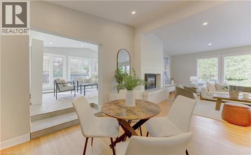 The interior features a fireplace with a mantel, recessed lighting, and large windows providing natural light - 400 Manchester Road, Kitchener, ON - Indoor With Fireplace