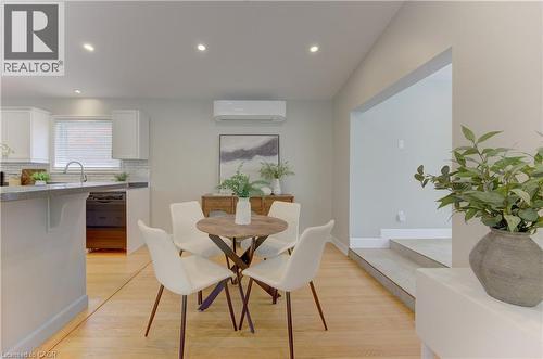 The property features an open living area with light wood flooring and recessed lighting - 400 Manchester Road, Kitchener, ON - Indoor Photo Showing Dining Room
