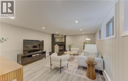 The living area features recessed lighting, light-toned flooring, and a dark-toned fireplace with a mantel - 400 Manchester Road, Kitchener, ON - Indoor Photo Showing Living Room