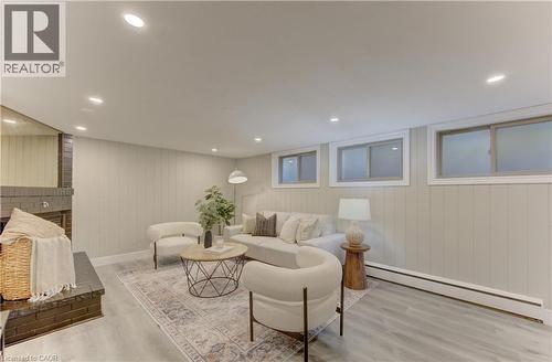 Living area featuring recessed lighting, paneled walls, and flooring with a wood grain finish - 400 Manchester Road, Kitchener, ON - Indoor