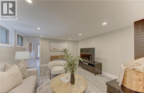 Living area featuring recessed lighting, light-colored walls, a brick fireplace, and light-toned flooring - 400 Manchester Road, Kitchener, ON - Indoor Photo Showing Other Room