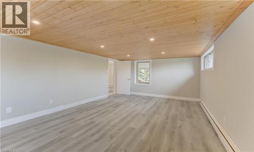 Spacious room featuring light-colored walls, light wood-style flooring, and a natural wood plank ceiling with recessed lighting - 400 Manchester Road, Kitchener, ON - Indoor Photo Showing Other Room