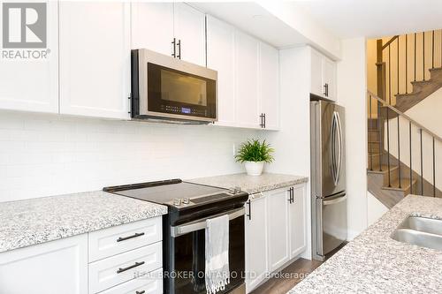 110 - 1593 Rose Way, Milton, ON - Indoor Photo Showing Kitchen With Stainless Steel Kitchen With Double Sink With Upgraded Kitchen