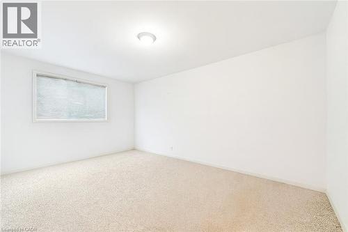 bedroom featuring carpet and baseboards - 21 Arden Avenue, Hamilton, ON 