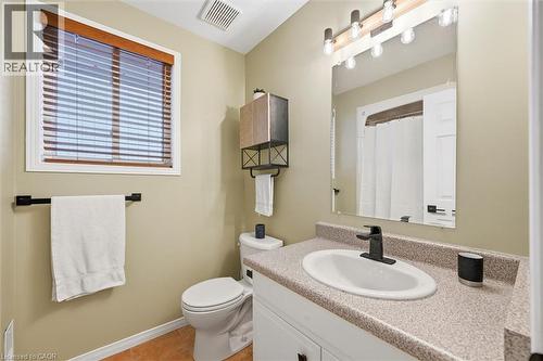 Bathroom with vanity, a shower with shower curtain, and light tile patterned floors - 21 Arden Avenue, Hamilton, ON 