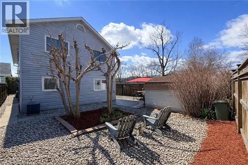 The property features a fenced yard with gravel and bark chip landscaping, and a patio area - 21 Arden Avenue, Hamilton, ON 