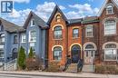 The property features a brick exterior with arched windows and a prominent gabled roofline - 198 Bay Street N, Hamilton, ON  - Outdoor With Facade 