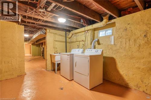 The property includes a dedicated laundry area with a washer, dryer, and utility sink - 198 Bay Street N, Hamilton, ON - Indoor Photo Showing Laundry Room