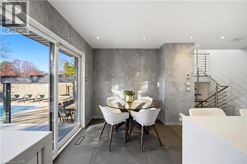 The property features a dining area with tiled flooring and walls, recessed lighting, and a glass-top table - 2467 Bonner Road, Mississauga, ON - Indoor