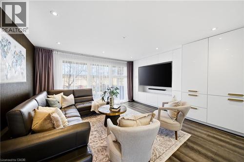 Living area featuring dark flooring, recessed lighting, and a wall of white high-gloss cabinetry with brass hardware - 2467 Bonner Road, Mississauga, ON - Indoor Photo Showing Living Room