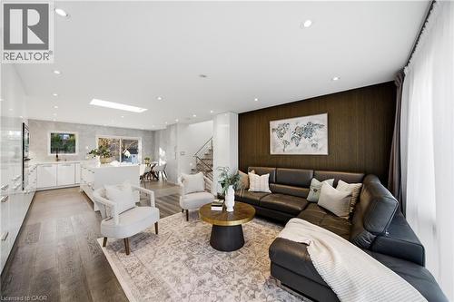 Spacious open-concept living area featuring hardwood flooring, recessed lighting, and large windows with sheer curtains - 2467 Bonner Road, Mississauga, ON - Indoor Photo Showing Living Room