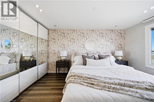 This room features hardwood flooring, recessed lighting, and a window providing natural light - 2467 Bonner Road, Mississauga, ON - Indoor Photo Showing Bedroom