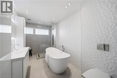 The bathroom features a freestanding bathtub, a walk-in shower with a glass enclosure, and a double vanity with two sinks - 2467 Bonner Road, Mississauga, ON - Indoor Photo Showing Bathroom