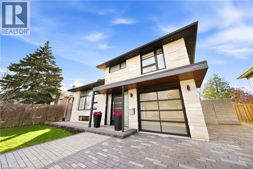 This property features a modern architectural style with a light-colored stone facade and dark trim - 2467 Bonner Road, Mississauga, ON - Outdoor