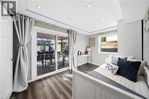 This room features dark wood flooring, recessed lighting, and sliding glass doors that open to an outdoor patio area - 2467 Bonner Road, Mississauga, ON - Indoor