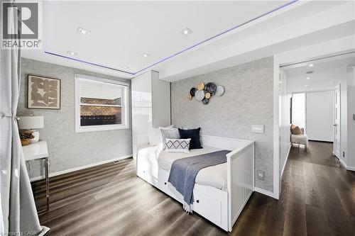 This room features dark hardwood flooring, recessed lighting, and a window with blinds - 2467 Bonner Road, Mississauga, ON - Indoor Photo Showing Bedroom