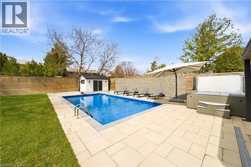 The property features a private backyard oasis with a swimming pool, a hot tub, and a paved patio area - 2467 Bonner Road, Mississauga, ON - Outdoor With In Ground Pool With Backyard