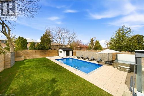 The property features a private backyard with a swimming pool, a hot tub, and a well-maintained lawn - 2467 Bonner Road, Mississauga, ON - Outdoor With In Ground Pool With Backyard