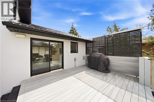 The property features a spacious outdoor deck with light-colored decking, a black slatted privacy screen, and direct access to the interior via a sliding glass door - 2467 Bonner Road, Mississauga, ON - Outdoor With Deck Patio Veranda With Exterior