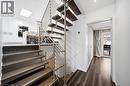 The property features modern architectural elements, including an open-tread staircase with metal railings and hardwood stairs - 2467 Bonner Road, Mississauga, ON  - Indoor Photo Showing Other Room 