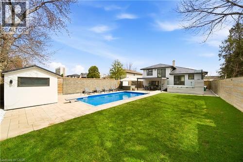 The property features a spacious backyard with a large swimming pool, a well-maintained lawn, and a separate structure - 2467 Bonner Road, Mississauga, ON - Outdoor With In Ground Pool With Backyard