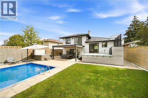 The property features a private backyard with a swimming pool, a hot tub, and a patio area - 2467 Bonner Road, Mississauga, ON - Outdoor With In Ground Pool