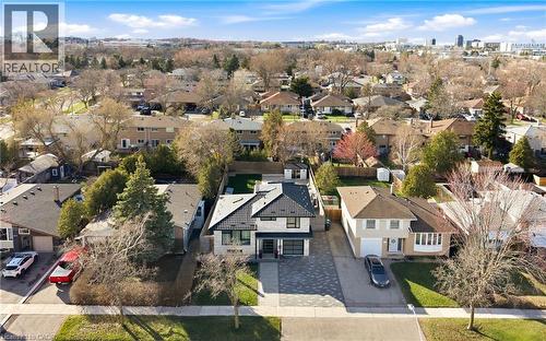 Aerial view of the property showing the residential neighborhood, the property's paved driveway, and the surrounding trees - 2467 Bonner Road, Mississauga, ON - Outdoor With View