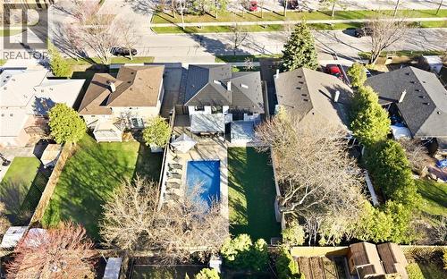 Aerial view of the property showcasing a private pool, an expansive lawn, and mature trees within the fenced yard - 2467 Bonner Road, Mississauga, ON - Outdoor With View