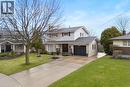 The property features a concrete driveway, a well-maintained lawn, and a mature tree in the front yard - 36 Buckingham Drive, Hamilton, ON  - Outdoor With Deck Patio Veranda With Facade 