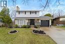 The property features a well-maintained lawn, decorative landscaping, and a paved driveway leading to an attached garage - 36 Buckingham Drive, Hamilton, ON  - Outdoor 