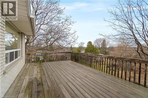 The property features an outdoor wooden deck with a wooden railing, providing a spacious area overlooking the surrounding landscape - 36 Buckingham Drive, Hamilton, ON - Outdoor With Deck Patio Veranda