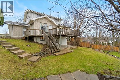 The property features a wood deck with stairs leading to a ground-level patio - 36 Buckingham Drive, Hamilton, ON - Outdoor With Deck Patio Veranda