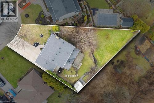 The property features an extensive yard with a lawn, a paved driveway, and mature trees - 36 Buckingham Drive, Hamilton, ON -  With View