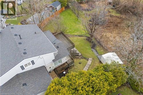 The property features a multi-level deck, a spacious yard with a lawn, mature trees, and a detached shed - 36 Buckingham Drive, Hamilton, ON - Outdoor