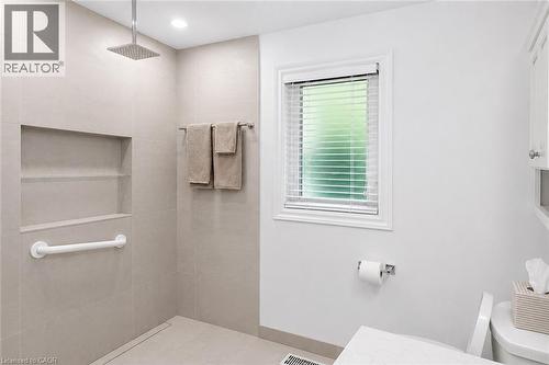 Tiled shower enclosure featuring a square rainfall shower head and built-in shelving - 23 Percy Court, Hamilton, ON - Indoor Photo Showing Bathroom