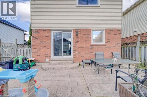The property features a brick and siding exterior, with a patio area providing outdoor living space - 334 Christopher Drive, Cambridge, ON - Outdoor With Deck Patio Veranda With Exterior
