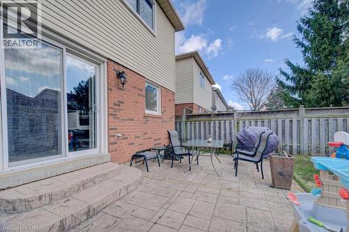 The property features a brick and siding exterior with a patio area - 334 Christopher Drive, Cambridge, ON - Outdoor With Exterior