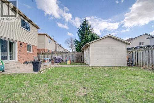 The property features a spacious backyard with a lawn, a patio, and a detached shed - 334 Christopher Drive, Cambridge, ON - Outdoor With Exterior