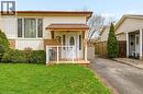 The property features a well-maintained lawn, a paved driveway, and established landscaping including hedges and evergreen trees - 2349 Middlesmoor Crescent, Burlington, ON  - Outdoor 