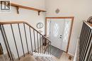 Inviting entryway featuring a white door with decorative glass inserts and light wood trim, complemented by a carpeted staircase with a wood handrail and metal spindles - 2349 Middlesmoor Crescent, Burlington, ON  - Indoor Photo Showing Other Room 