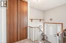 Entryway featuring a white door with decorative glass inserts, a wood-framed mirror, and a wooden railing - 2349 Middlesmoor Crescent, Burlington, ON  - Indoor Photo Showing Other Room 