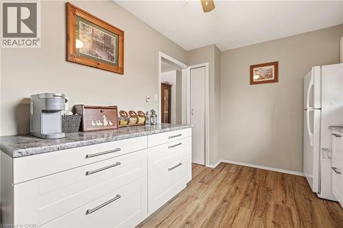 Kitchen featuring wood-style flooring, white cabinetry with silver-toned hardware, and a white refrigerator - 2349 Middlesmoor Crescent, Burlington, ON - Indoor Photo Showing Kitchen